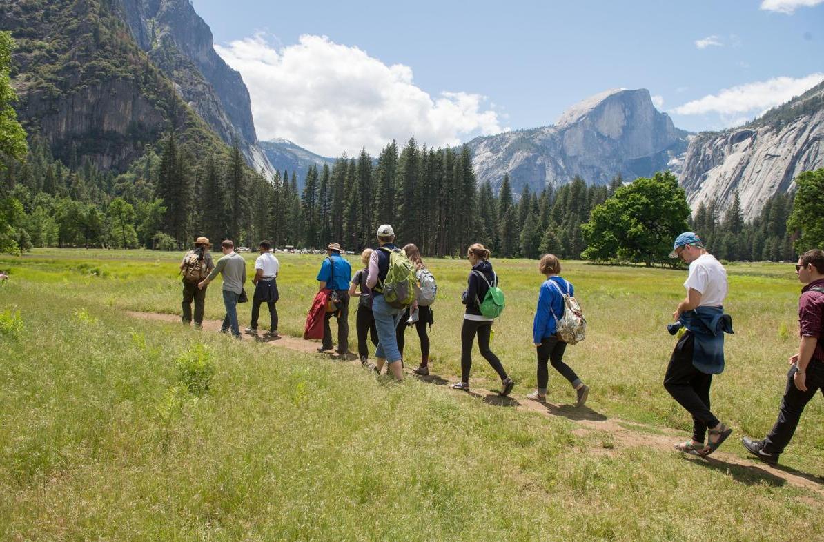 students walking a trial in a valley of Yosemite National Park 